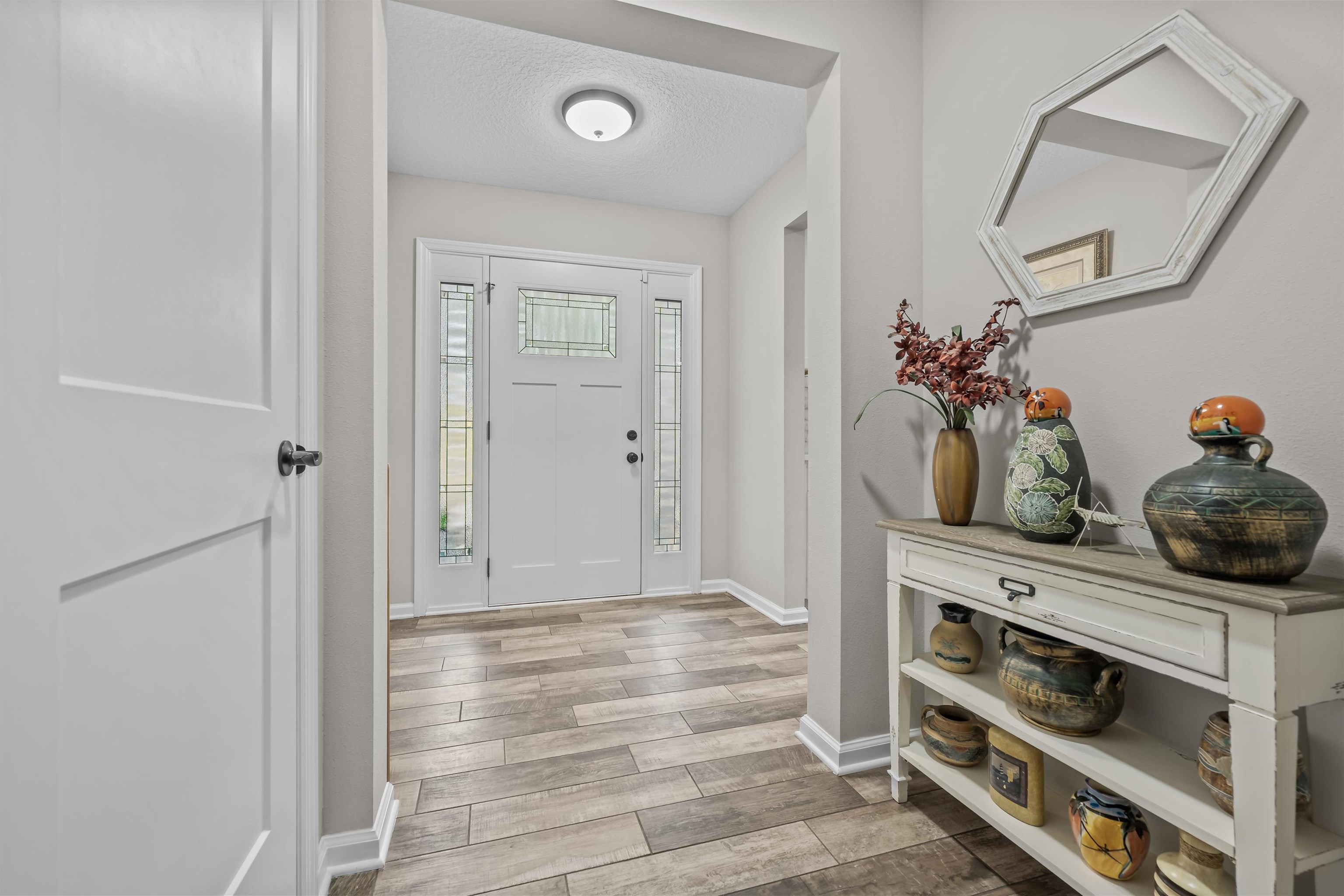 232 Kyte Road San Mateo, FL 32187 - Photo 4 of 36 Entrance foyer featuring wood tiled floors and a textured ceiling