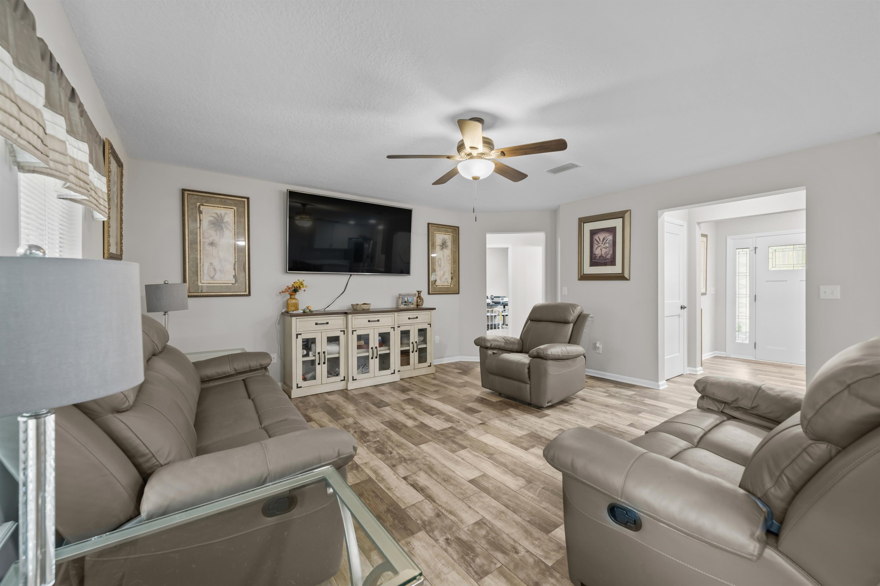 232 Kyte Road San Mateo, FL 32187 - Photo 5 of 36 Living area with light wood finished floors and a ceiling fan