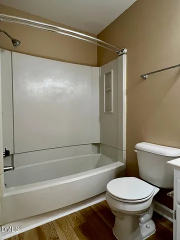 a bathroom with a toilet and a bath tub