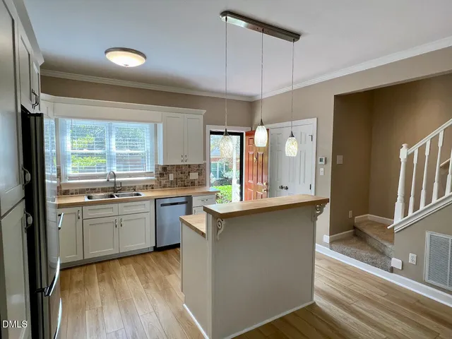 a kitchen with a sink dishwasher stove and refrigerator