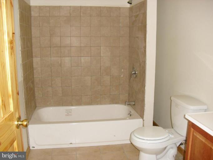 21 Riggs Lane Capon Bridge, WV 26711 - Photo 14 of 24 a bathroom with a toilet and a bathtub