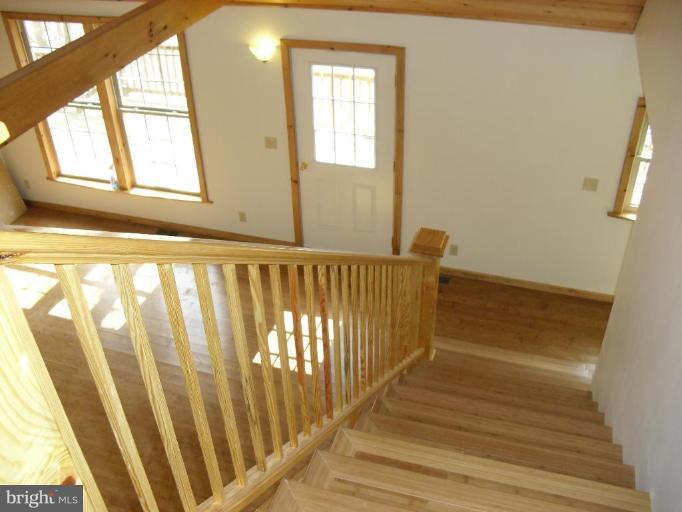 21 Riggs Lane Capon Bridge, WV 26711 - Photo 19 of 24 a view of a room with wooden floor and chair