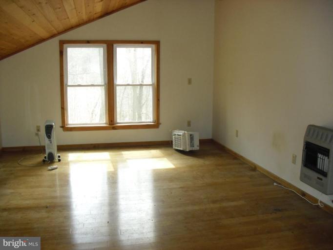 21 Riggs Lane Capon Bridge, WV 26711 - Photo 23 of 24 a view of empty room with wooden floor and fan