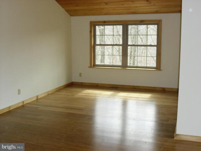 21 Riggs Lane Capon Bridge, WV 26711 - Photo 4 of 24 an empty room with wooden floor and windows