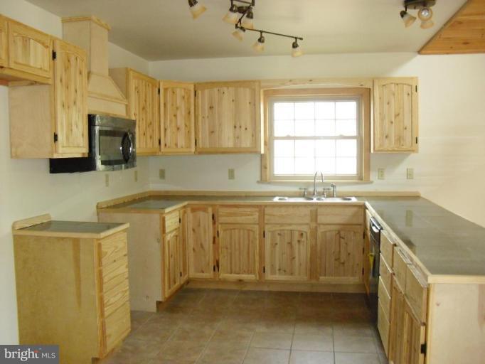 21 Riggs Lane Capon Bridge, WV 26711 - Photo 6 of 24 a bathroom with a granite countertop sink and a mirror