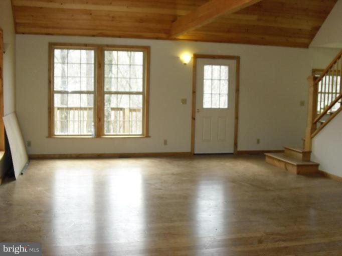21 Riggs Lane Capon Bridge, WV 26711 - Photo 8 of 24 an empty room with wooden floor and windows