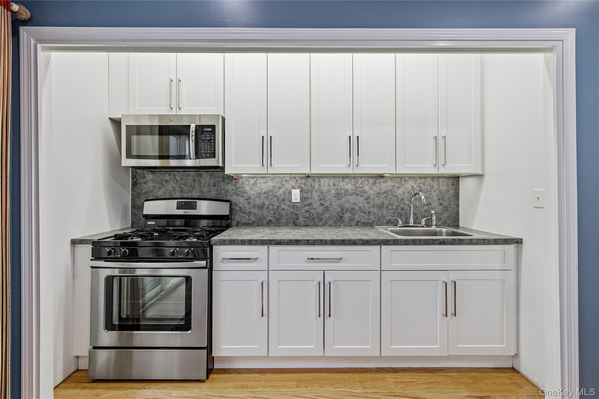 3314 Parkview Drive Spring Valley, NY 10977 - Photo 13 of 34 a kitchen with granite countertop white cabinets and stainless steel appliances