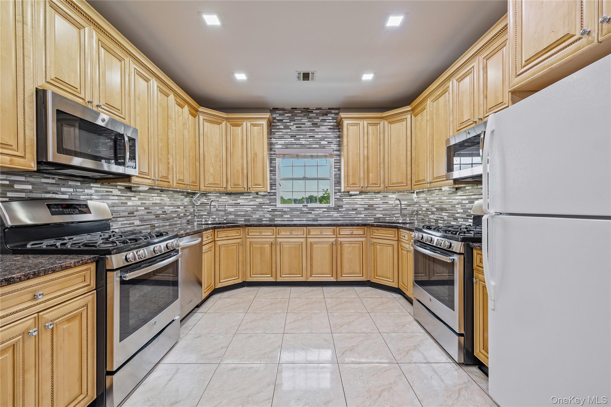 3314 Parkview Drive Spring Valley, NY 10977 - Photo 18 of 34 a kitchen with stainless steel appliances granite countertop a stove a sink and a microwave