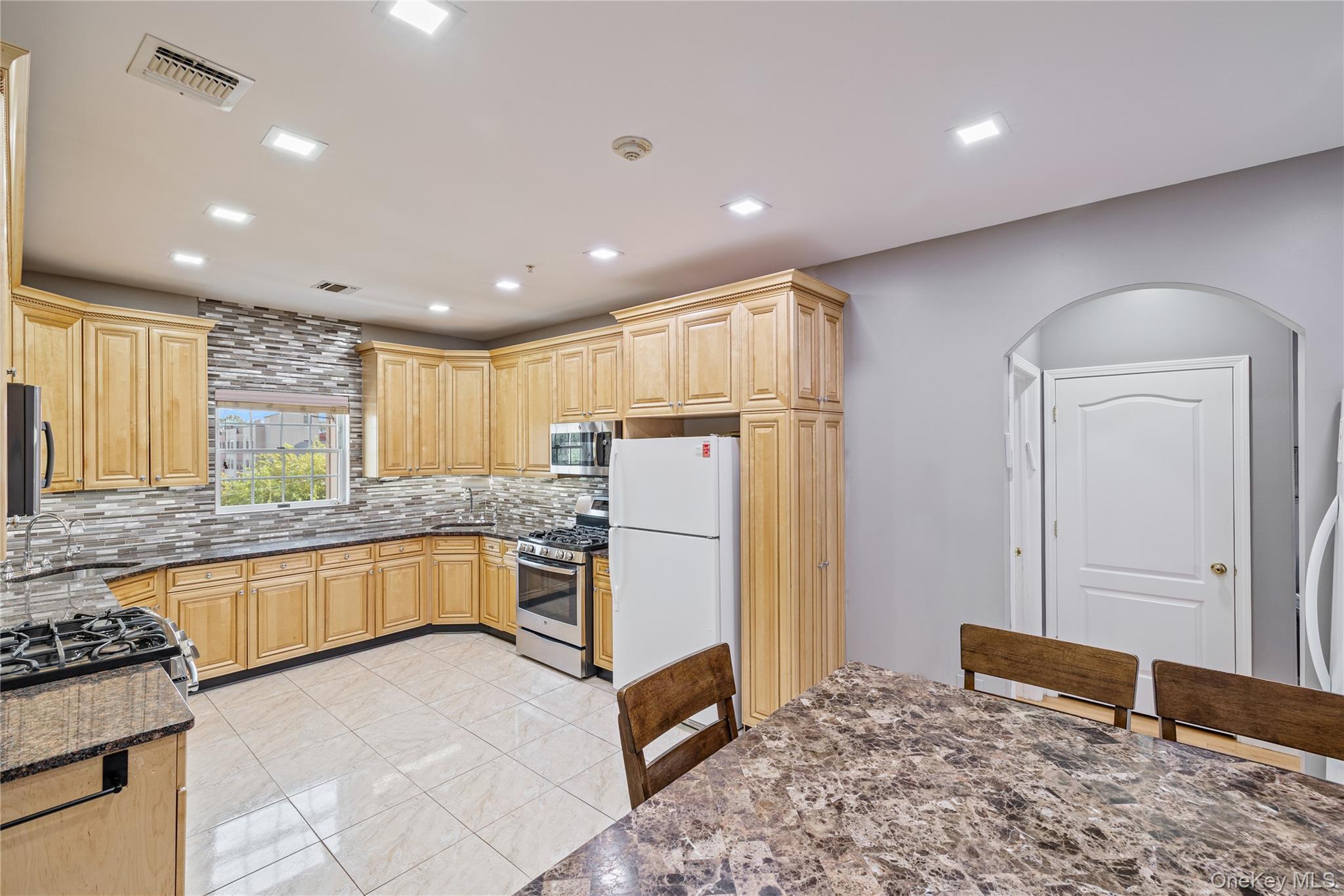 3314 Parkview Drive Spring Valley, NY 10977 - Photo 19 of 34 a kitchen with a refrigerator and a stove top oven