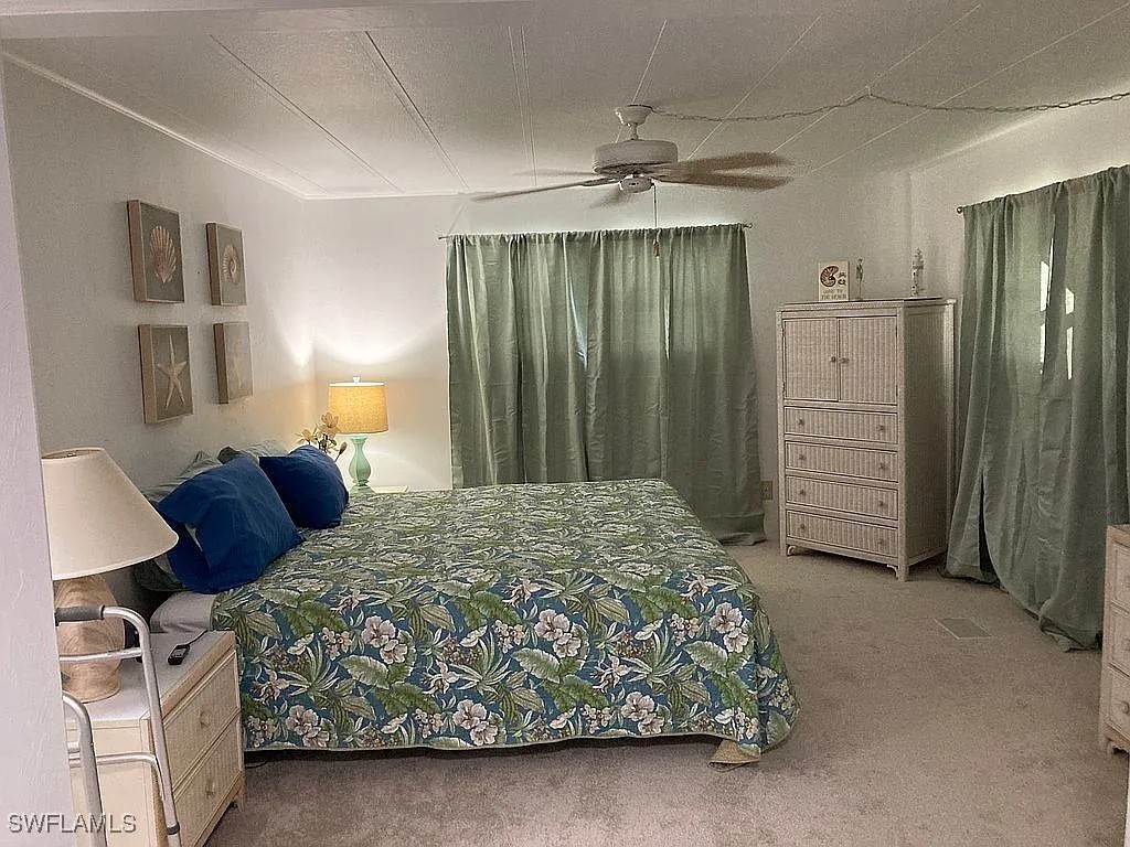 1 Elder Alva, FL 33920 - Photo 8 of 23 a bedroom with a bed and a chandelier