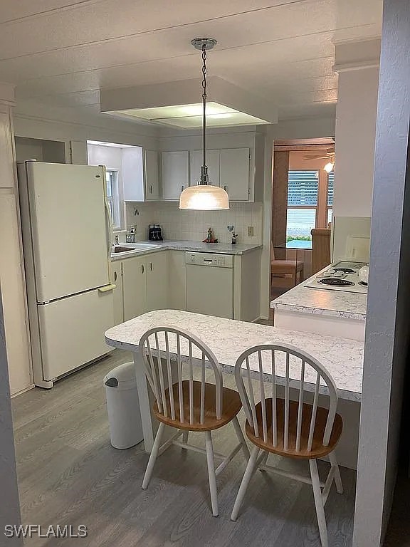 1 Elder Alva, FL 33920 - Photo 9 of 23 a kitchen with stainless steel appliances granite countertop a dining table chairs a refrigerator and a chandelier