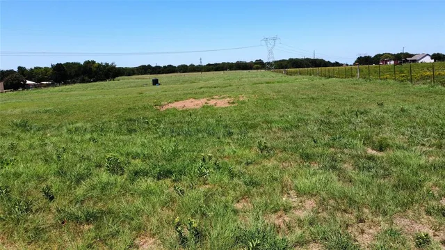 a view of a grassy field and an ocean
