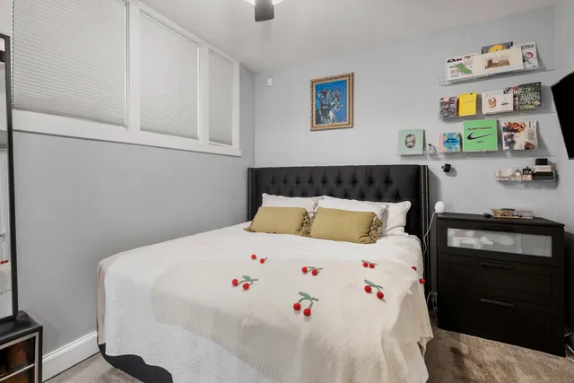 a bedroom with a bed and a desk