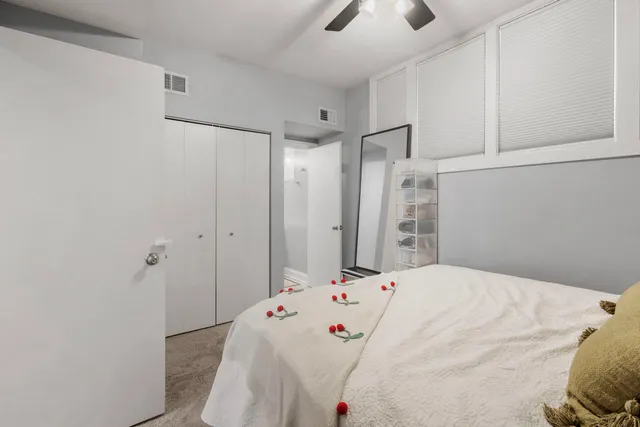 a bedroom with a bed and a chandelier