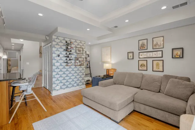 a living room with furniture and a floor to ceiling window