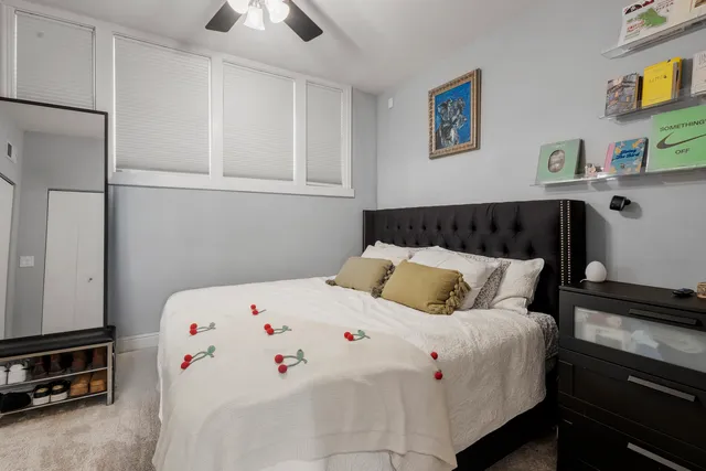 a bedroom with a bed and a chandelier