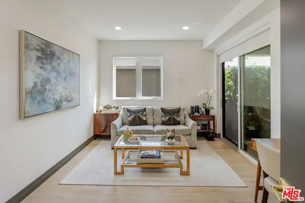 a lobby with furniture and potted plants