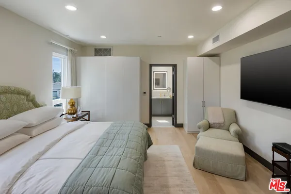 a bedroom with a bed and a couch