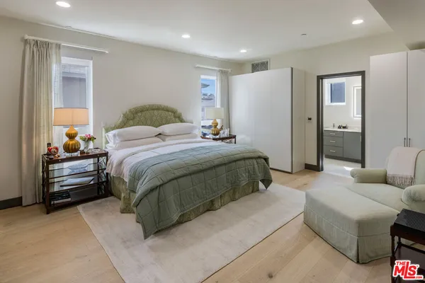 a bedroom with a bed and a flat screen television