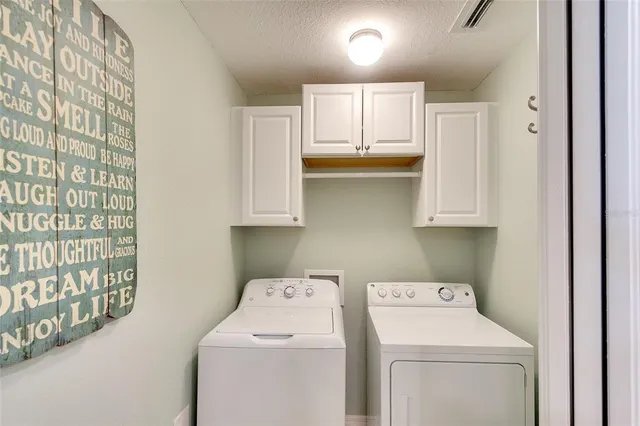 a large room with lots of tables a chandelier and couches