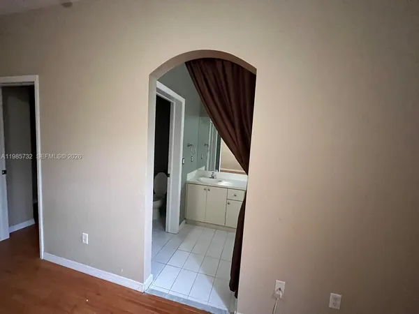 a view of a room with wooden floor and sink