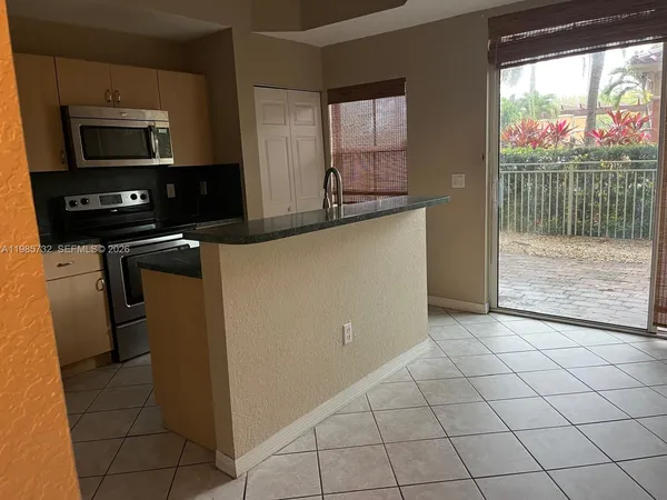 a kitchen with a sink a stove and cabinets