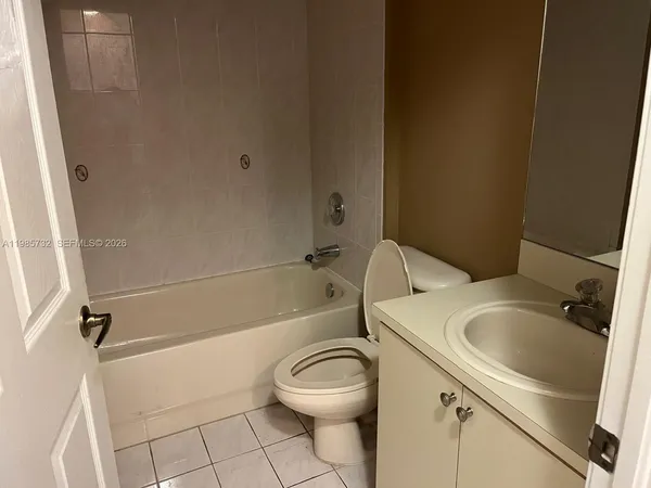 a white toilet sitting next to a bath tub