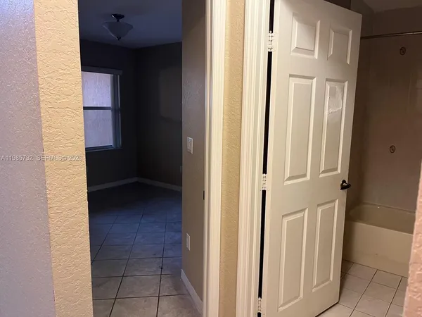 a bathroom with a glass shower door and sink