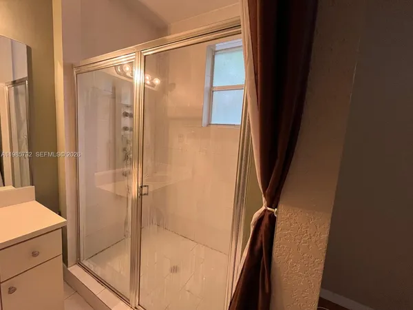 an empty room with wooden floor and sliding door