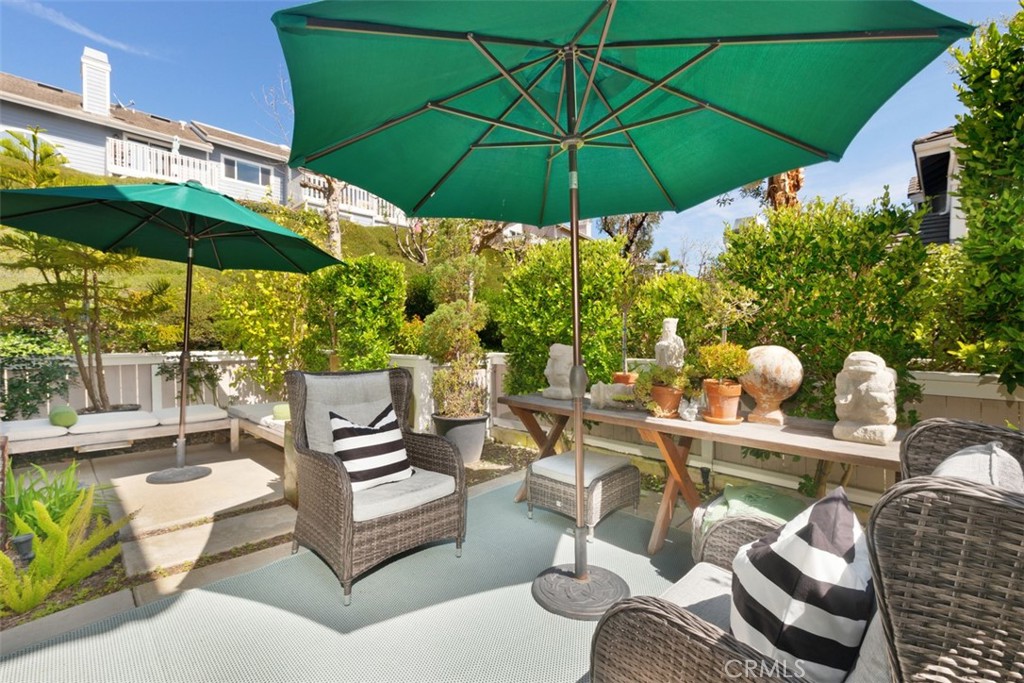 14 Pickney Close Laguna Niguel, CA 92677 - Photo 12 of 22 a view of a patio with couches under an umbrella