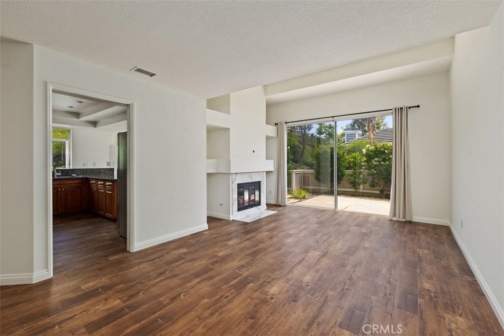 14 Pickney Close Laguna Niguel, CA 92677 - Photo 15 of 22 a view of a big room with wooden floor fireplace and a window
