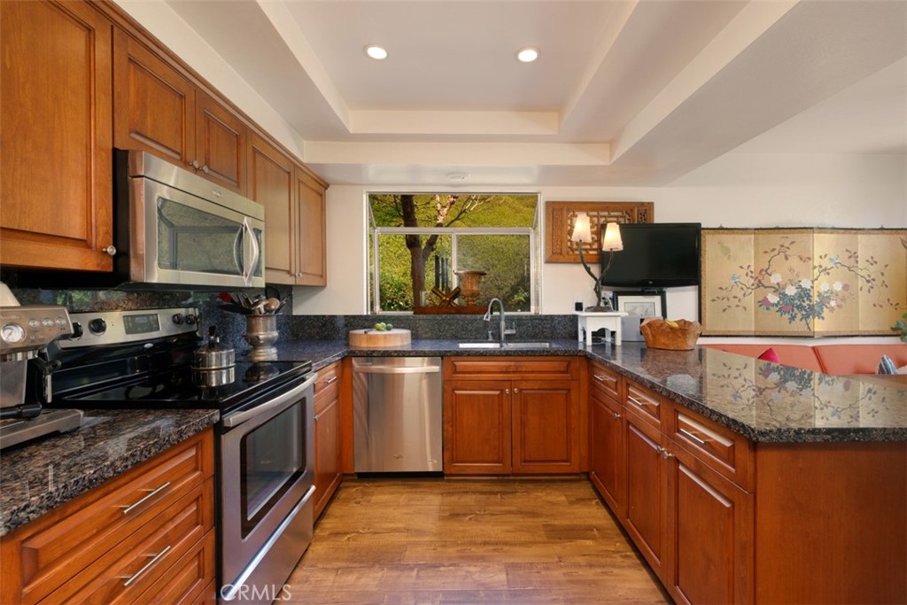 14 Pickney Close Laguna Niguel, CA 92677 - Photo 6 of 22 a large kitchen with stainless steel appliances granite countertop a stove a sink and a microwave