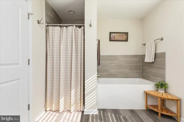 a bathroom with a bathtub and a shower
