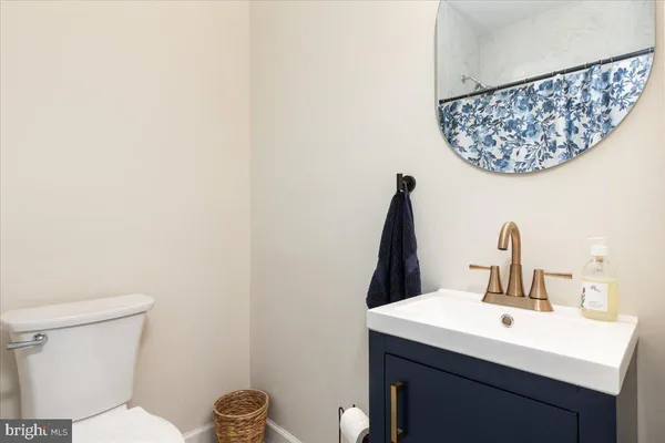 a bathroom with a sink mirror and toilet