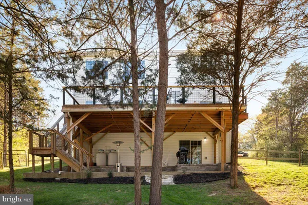 a view of house with yard in front of house