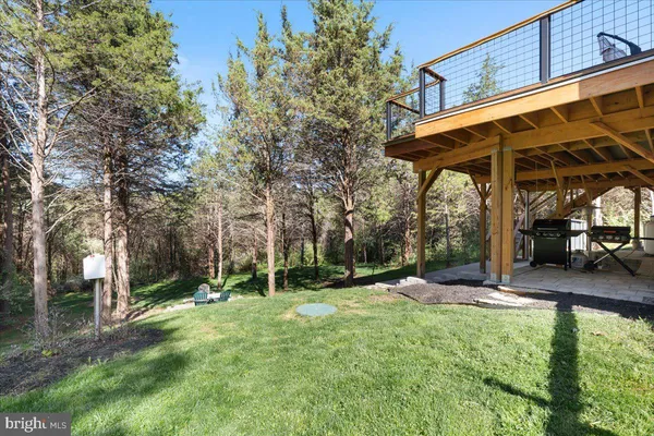 a view of a backyard with table and chairs under an umbrella
