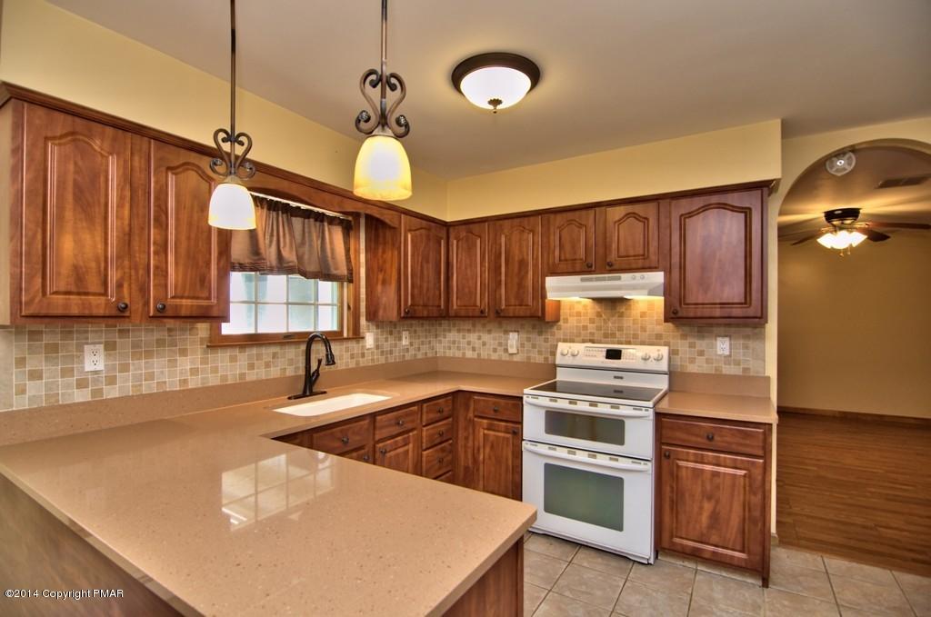 4161 Hickory Road Tobyhanna, PA 18466 - Photo 11 of 31 a kitchen with wooden cabinets and stainless steel appliances