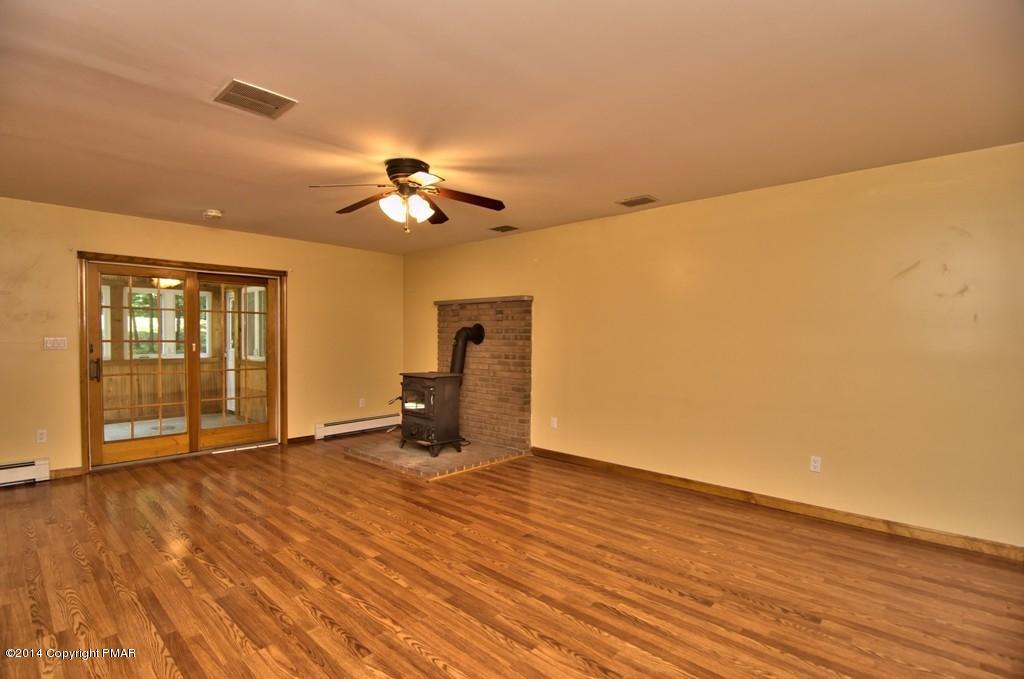 4161 Hickory Road Tobyhanna, PA 18466 - Photo 14 of 31 a view of an empty room with wooden floor and a ceiling fan
