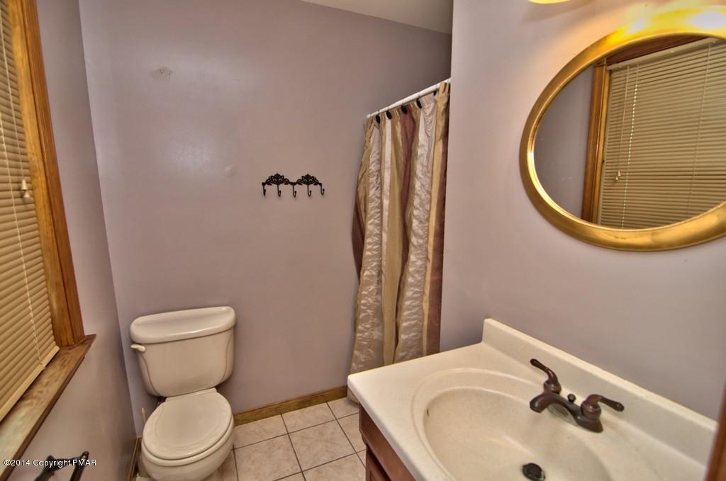 4161 Hickory Road Tobyhanna, PA 18466 - Photo 21 of 31 a bathroom with a sink a toilet and a mirror