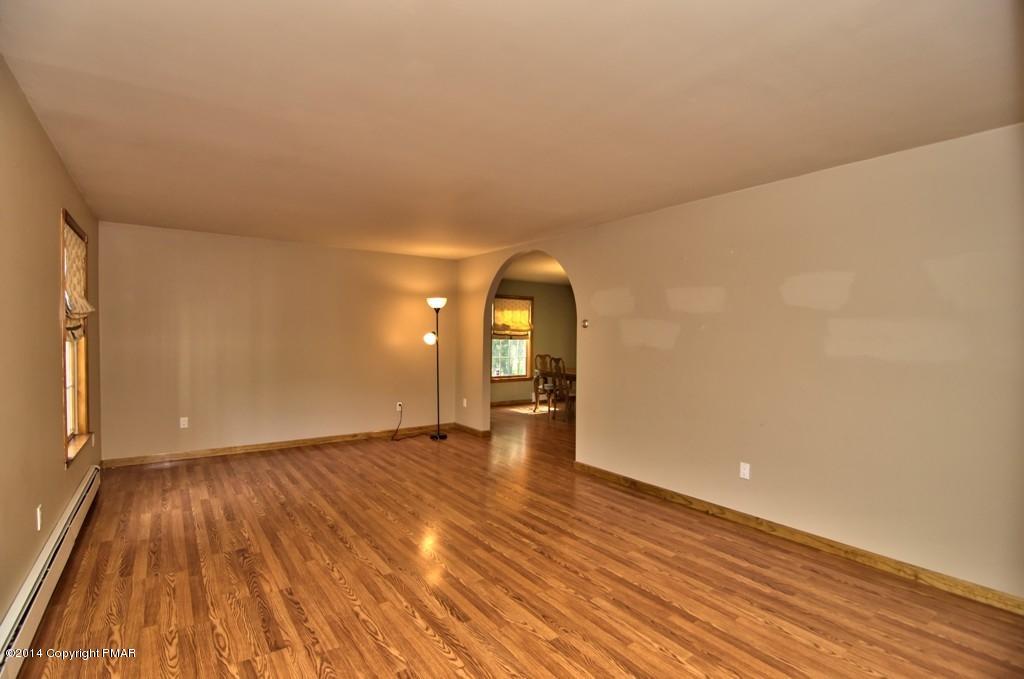 4161 Hickory Road Tobyhanna, PA 18466 - Photo 5 of 31 a view of empty room with wooden floor and fan