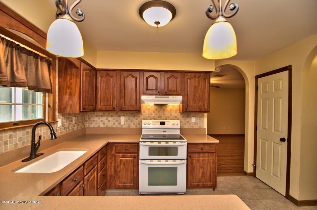 4161 Hickory Road Tobyhanna, PA 18466 - Photo 10 of 31 a kitchen with stainless steel appliances granite countertop a stove a sink and a microwave