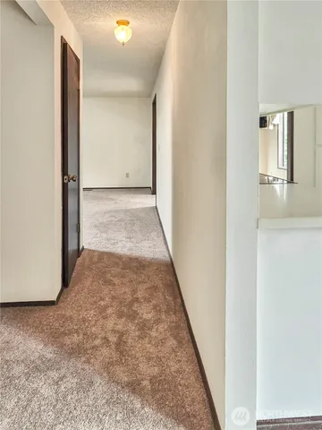 a bathroom with a granite countertop toilet sink and mirror