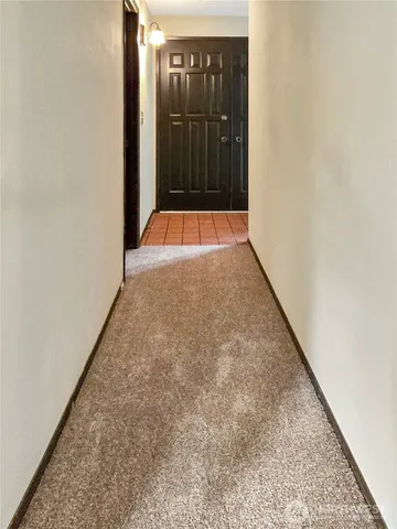 a view of staircase with lots of frames on wall
