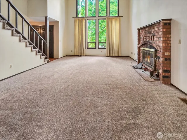 a view of a livingroom with furniture and staircase