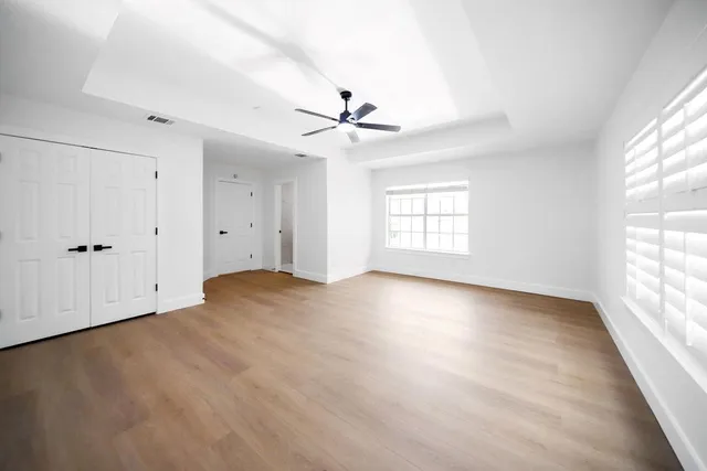 wooden floor in an empty room with a window