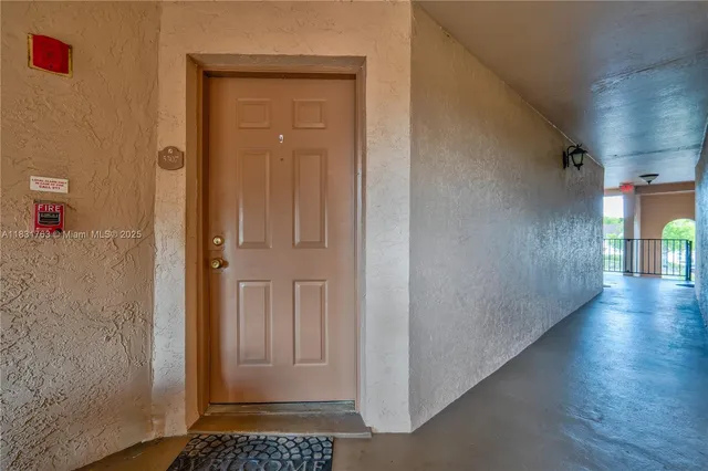 a view of a hallway with wooden floor and a cabinet