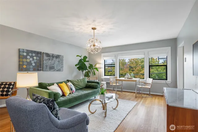 a living room with furniture and a chandelier