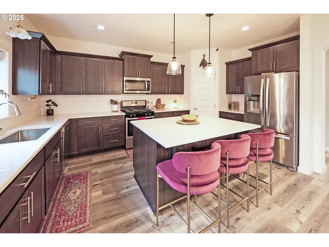 a kitchen with a sink refrigerator and cabinets