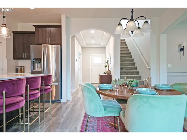 a view of a dining room with furniture and a chandelier