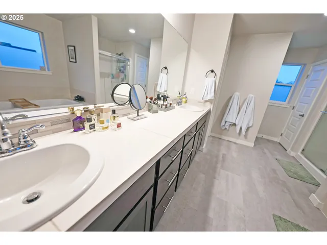 a bathroom with a granite countertop sink a mirror and vanity